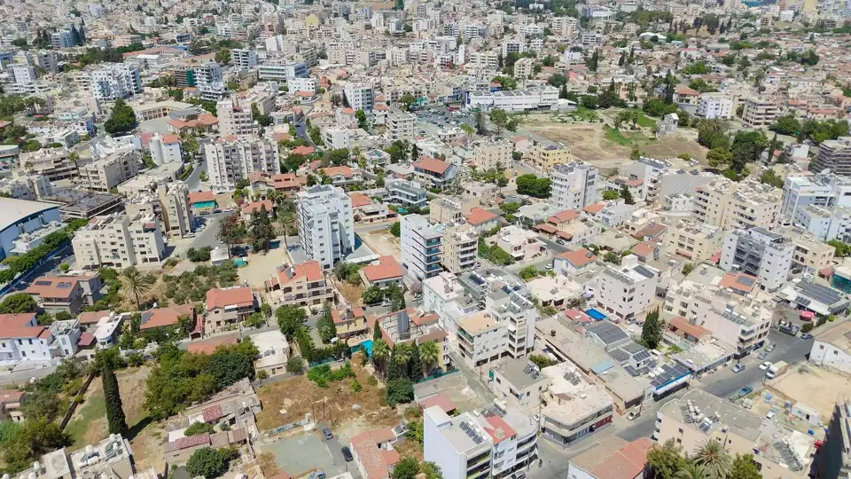 Aerial photograph over densely built central Larnaca rooftops and apartment blocks