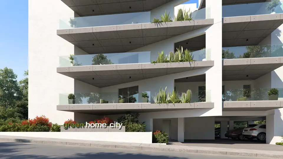 Close render of the facade showing cascading balcony planting above the covered parking entrance