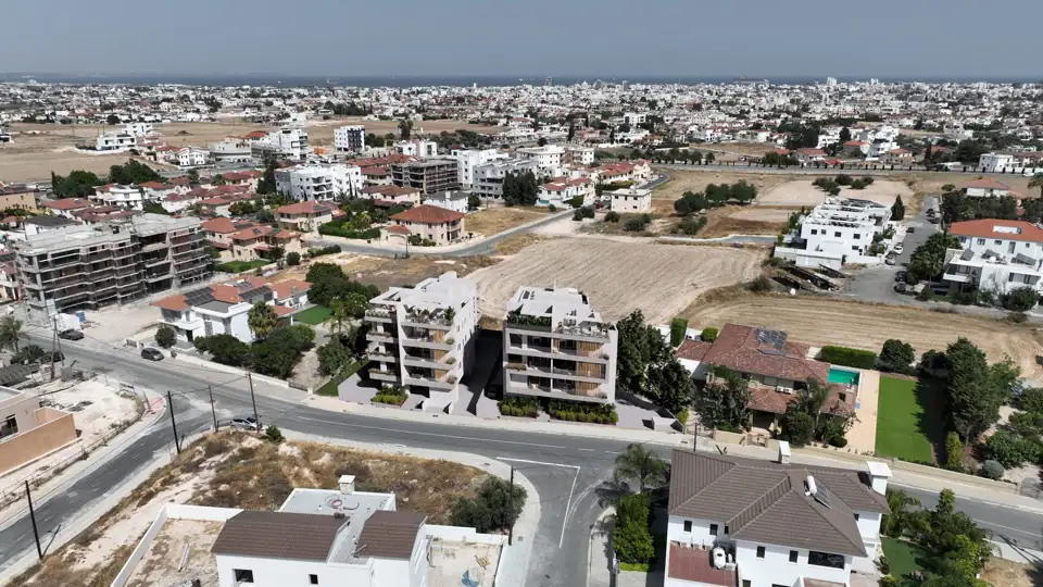 Aerial photograph of the completed white block among low-rise suburban Larnaca rooftops
