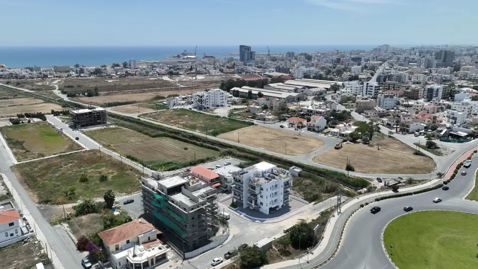 Aerial photograph of the buildings on their corner plot with the sea on the horizon